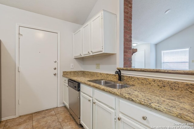 kitchen with lofted ceiling, white cabinets, dishwasher, and a sink