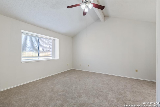 carpeted empty room featuring vaulted ceiling with beams, baseboards, and a ceiling fan