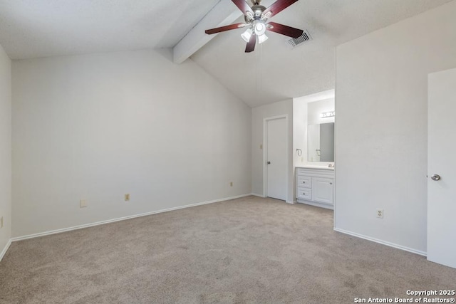 unfurnished bedroom featuring visible vents, lofted ceiling with beams, ensuite bathroom, light carpet, and baseboards