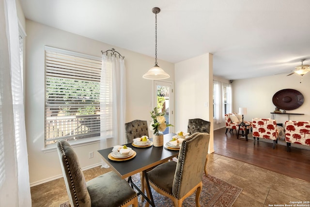 tiled dining area featuring baseboards