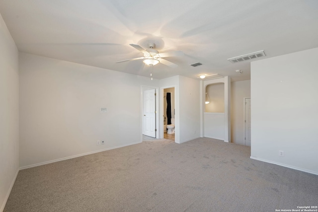 empty room featuring light colored carpet, visible vents, ceiling fan, and baseboards