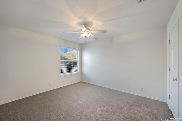 carpeted empty room featuring visible vents, ceiling fan, and baseboards