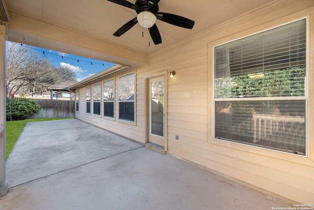 view of patio / terrace featuring ceiling fan and fence