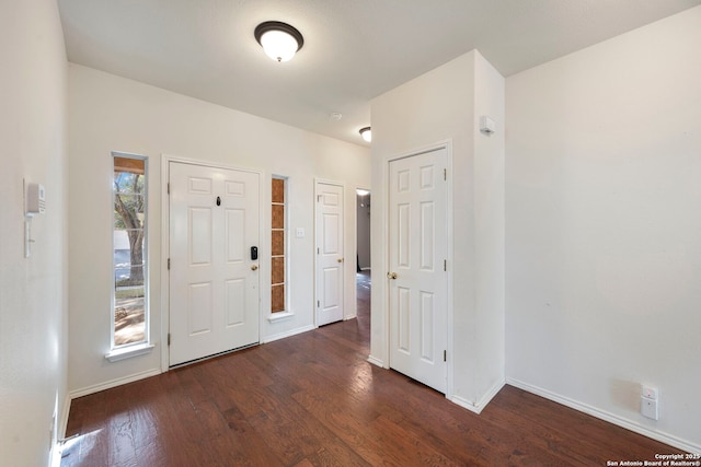 foyer with baseboards and wood finished floors