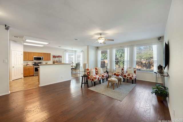 living area featuring a healthy amount of sunlight, hardwood / wood-style flooring, and visible vents