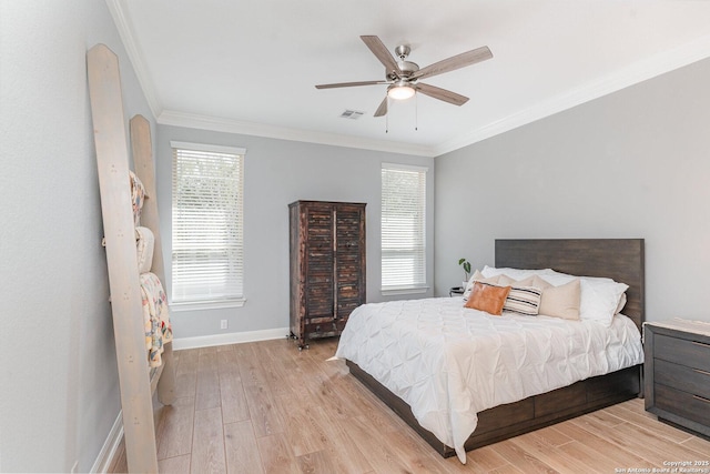 bedroom with crown molding, baseboards, visible vents, and light wood-style floors