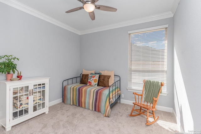 bedroom featuring ceiling fan, baseboards, crown molding, and carpet flooring