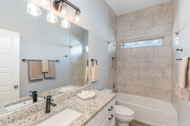 bathroom with toilet, vanity, and shower / bathtub combination