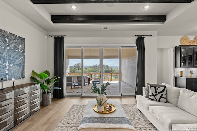 living room with visible vents, a raised ceiling, beamed ceiling, light wood-style floors, and recessed lighting