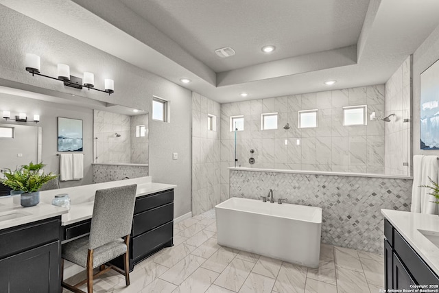 bathroom with marble finish floor, walk in shower, vanity, and recessed lighting