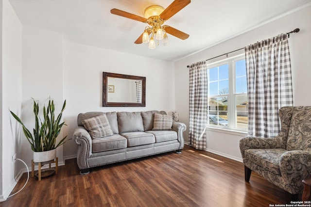 living room with wood finished floors, a ceiling fan, and baseboards