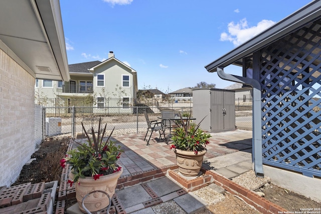 view of patio featuring fence, an outdoor structure, and outdoor dining space