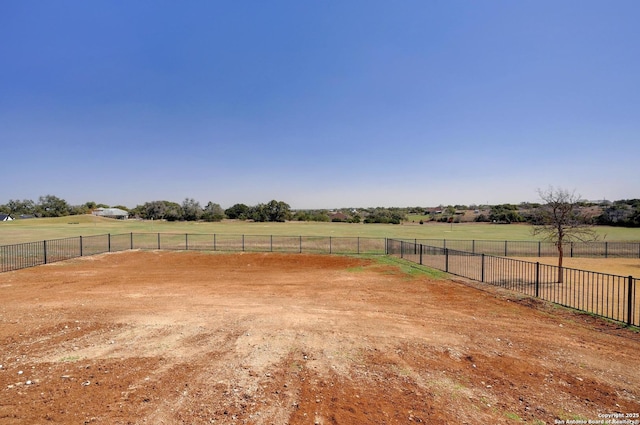 view of yard with a rural view and fence