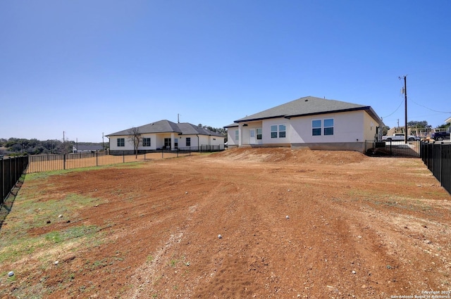 rear view of property featuring a fenced backyard