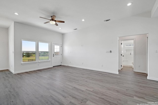 unfurnished living room with baseboards, wood finished floors, visible vents, and recessed lighting