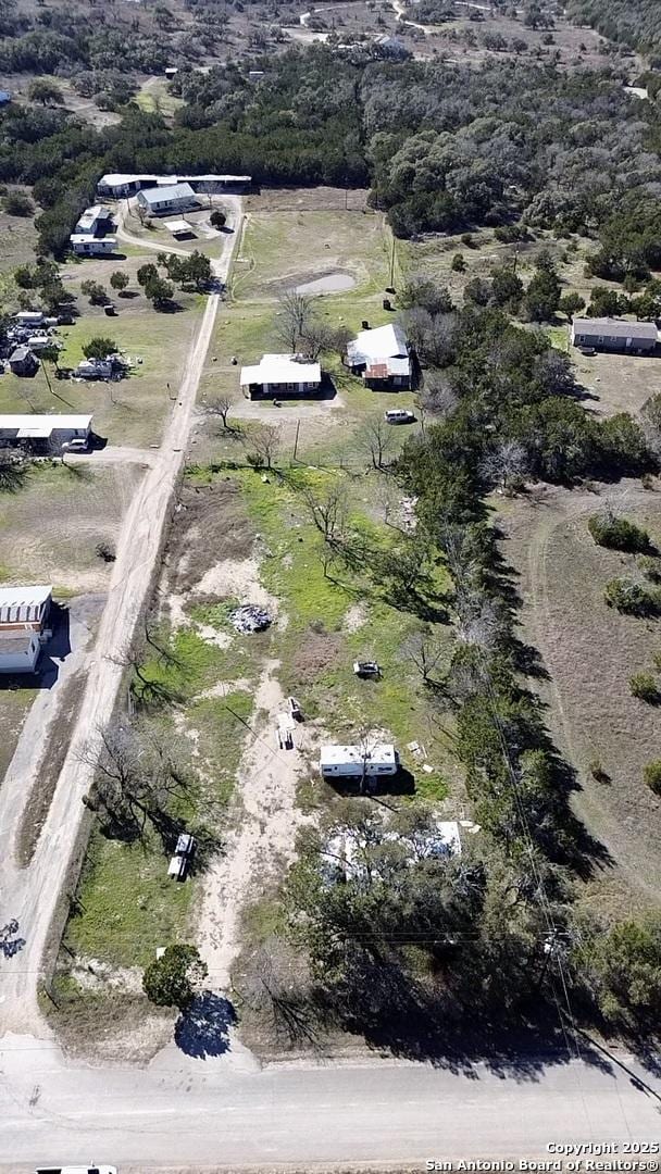 birds eye view of property with a rural view