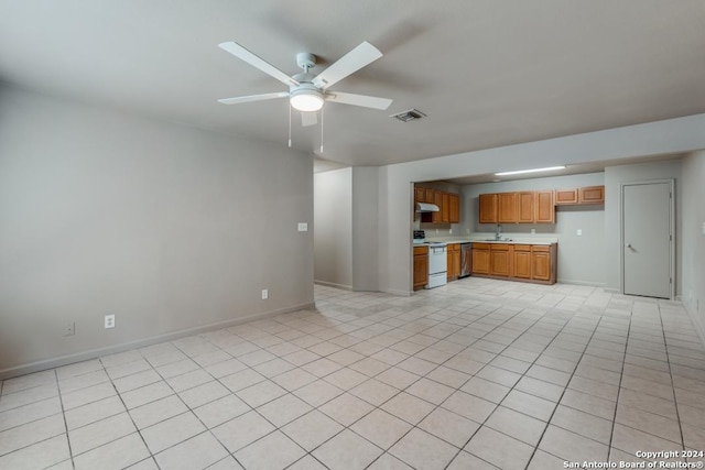 kitchen featuring visible vents, light countertops, a ceiling fan, range, and under cabinet range hood