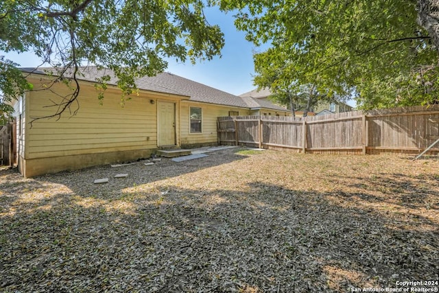 back of house featuring fence private yard