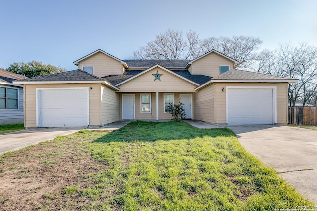 view of front of home with an attached garage, driveway, and fence