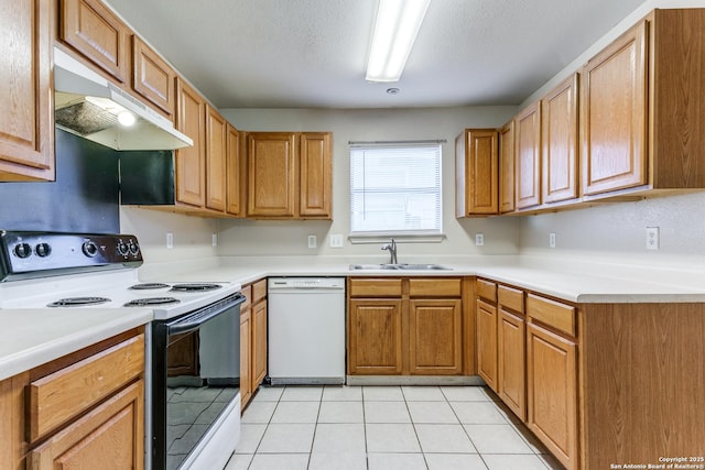 kitchen featuring a sink, a textured ceiling, range with electric cooktop, dishwasher, and under cabinet range hood