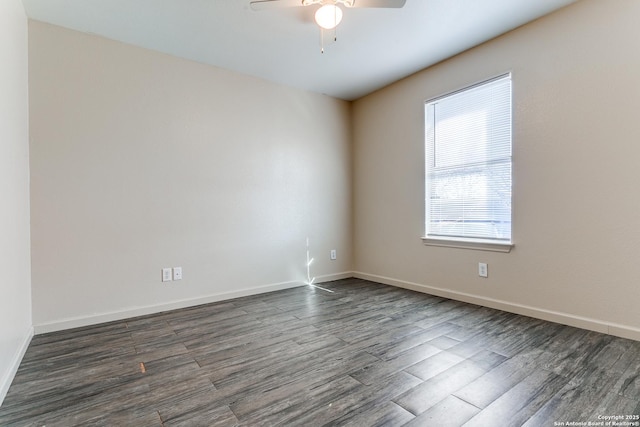 empty room featuring ceiling fan, baseboards, and dark wood finished floors