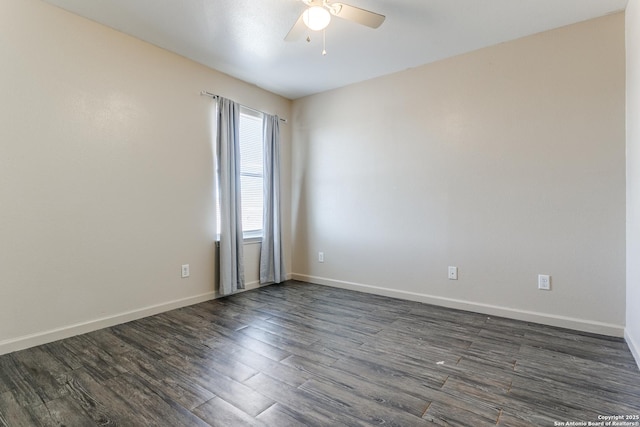 empty room featuring dark wood-type flooring, a ceiling fan, and baseboards