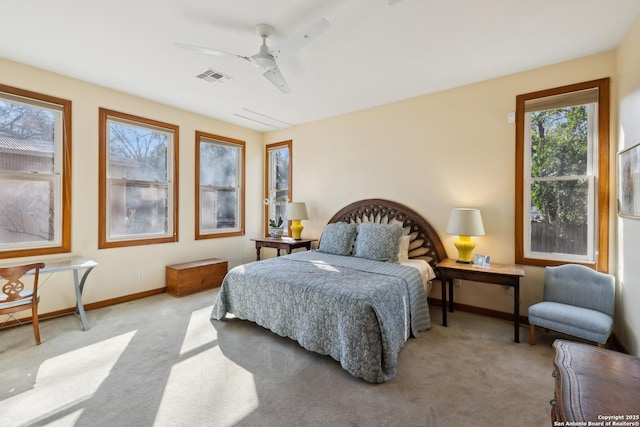 carpeted bedroom featuring visible vents, ceiling fan, and baseboards