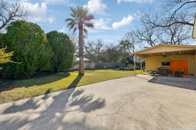 view of patio / terrace with driveway and fence