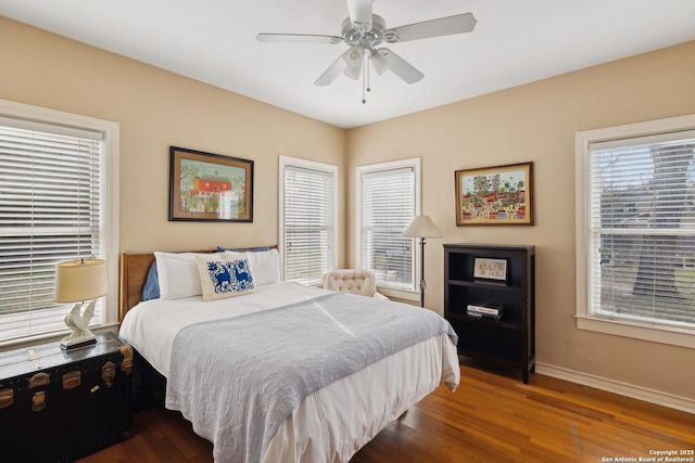 bedroom featuring a ceiling fan, baseboards, and wood finished floors