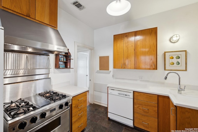 kitchen featuring high end stainless steel range, white dishwasher, and brown cabinetry