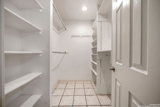 spacious closet featuring light tile patterned flooring