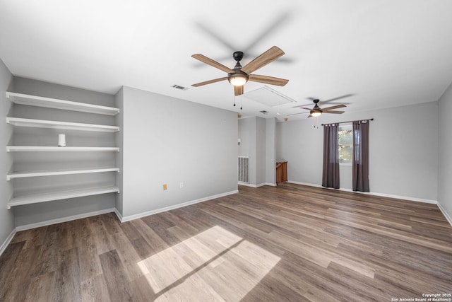 interior space featuring visible vents, baseboards, and wood finished floors