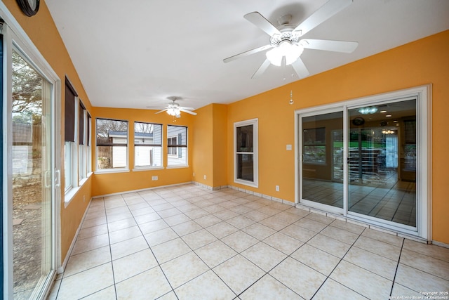 unfurnished sunroom with ceiling fan