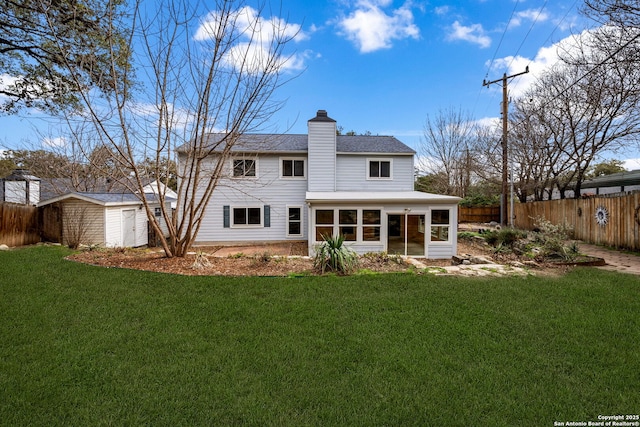 rear view of property featuring a sunroom, fence, a chimney, and a lawn