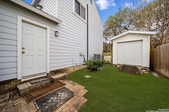 exterior space with a yard, central AC, and fence