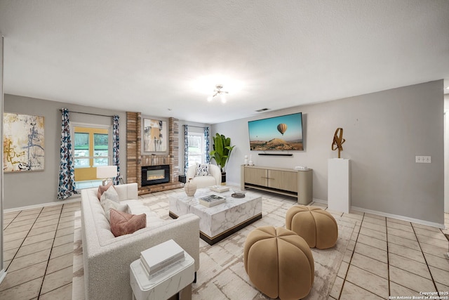 living room with a fireplace, baseboards, and tile patterned floors