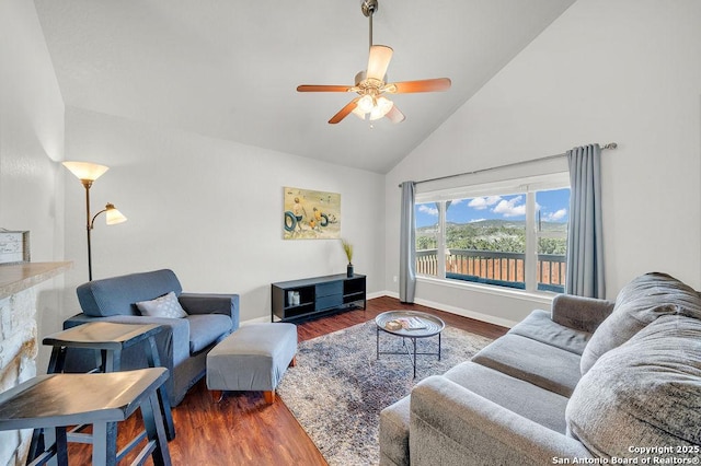 living room featuring high vaulted ceiling, ceiling fan, baseboards, and wood finished floors