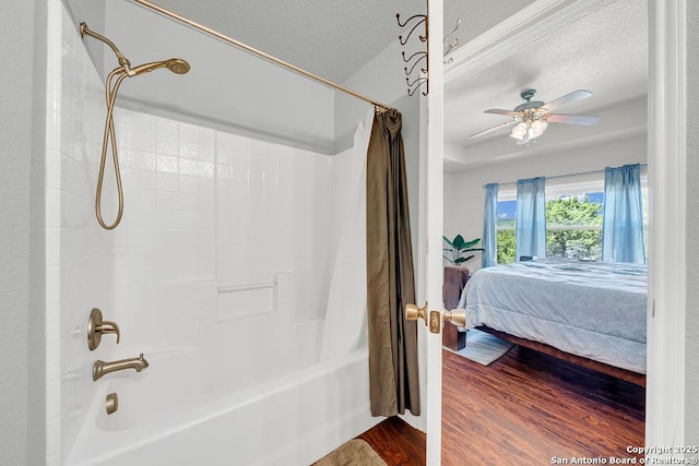 bathroom featuring shower / tub combo, ceiling fan, a textured ceiling, and wood finished floors