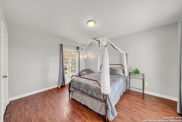 bedroom with wood finished floors and baseboards