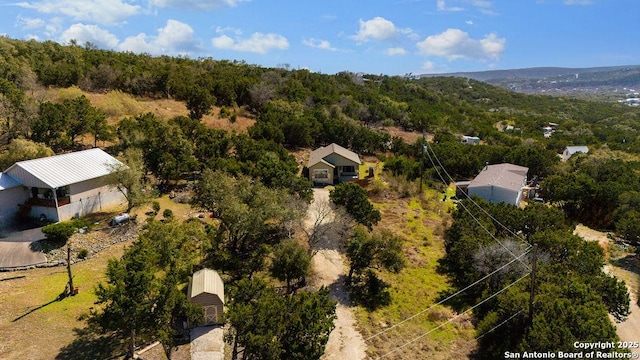 drone / aerial view featuring a forest view