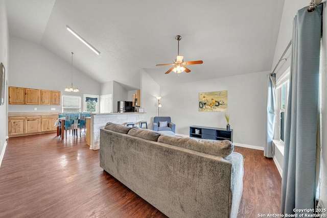 living room featuring high vaulted ceiling, dark wood finished floors, baseboards, and ceiling fan with notable chandelier