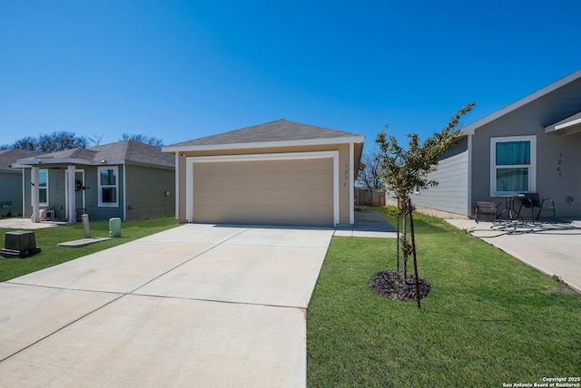 single story home with a garage, an outbuilding, and a front yard