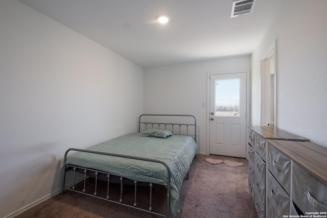 carpeted bedroom featuring visible vents