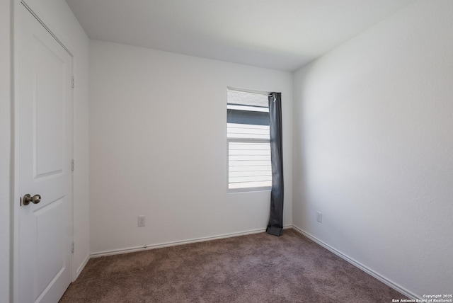 spare room with carpet floors and baseboards