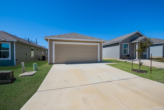 view of front of home with cooling unit, an outdoor structure, a detached garage, roof with shingles, and a front yard