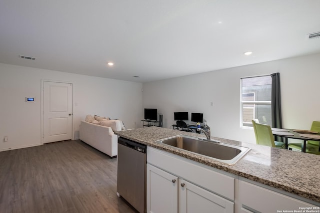 kitchen featuring visible vents, open floor plan, white cabinetry, a sink, and dishwasher