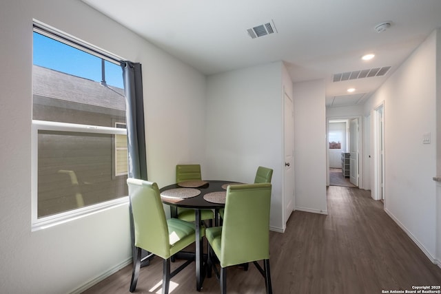 dining area with baseboards, visible vents, wood finished floors, and recessed lighting