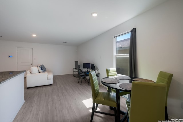 dining space featuring light wood-style flooring and recessed lighting