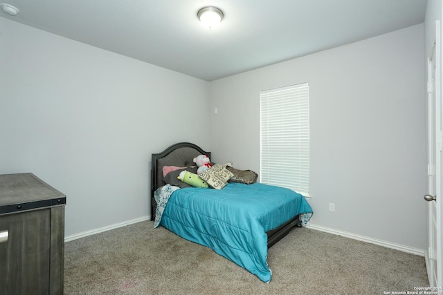 bedroom with carpet floors and baseboards