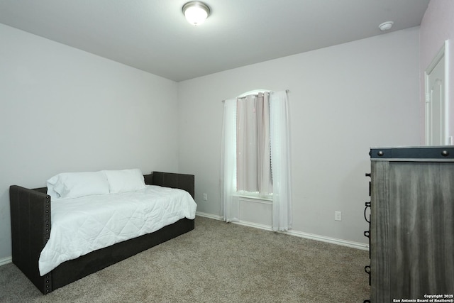 carpeted bedroom with baseboards